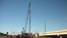 Placing the reinforcing cage in the drilled shaft for the La Cholla Boulevard bridge over the Canyon Del Oro Wash.