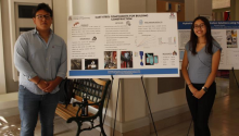 Alejandro Ceballos Olivas and Jennifer Galvan-Garcia standing in front of their research poster about cast steel components for building construction. 