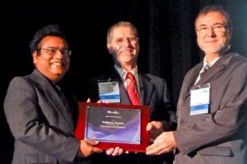 Tribikram Kundu, left, receives his prize from SPIE symposium chair Norbert Meyendorf, right, and symposium co-chair Victor Giurgiutiu of the University of South Carolina, center.