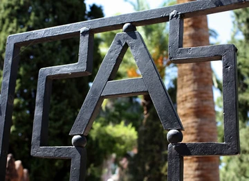 block A logo on bronze gate